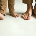 Pies caminando sobre revestimiento decorativo para conocer los beneficios de caminar descalzo sobre microcemento.