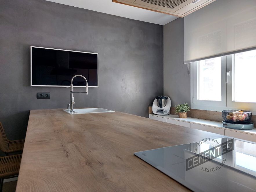 Refurbished kitchen with Cementec Standard on walls and wooden worktop, especially for wet areas.