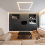 Main living room where the combination of microcement and natural wood can be seen.