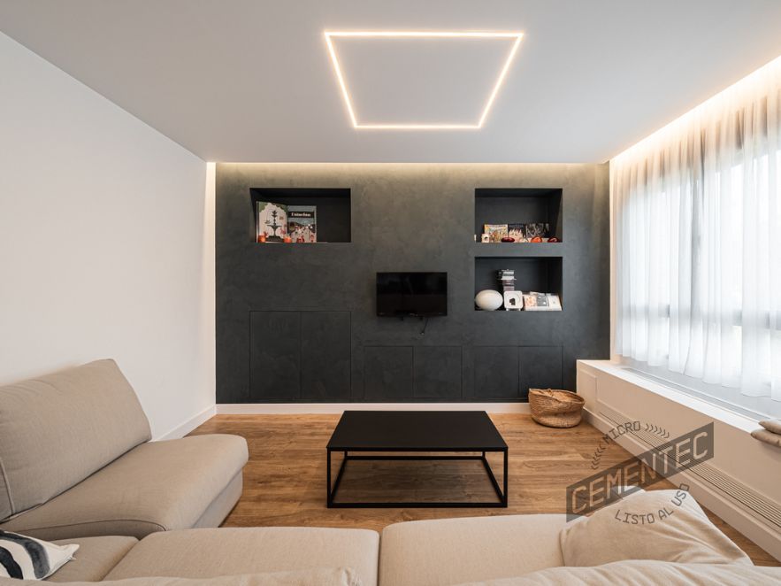 Main living room where the combination of microcement and natural wood can be seen.