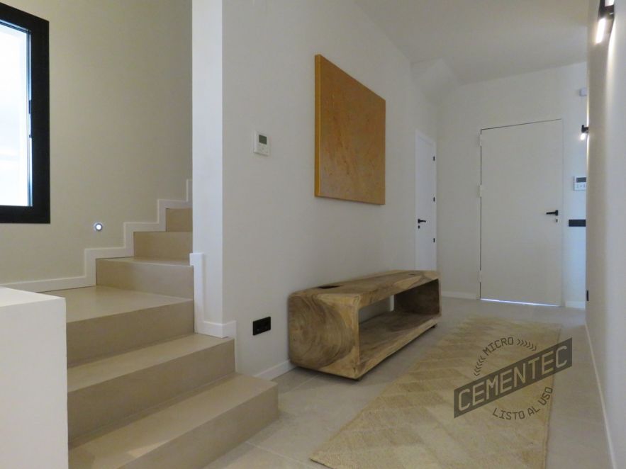 Microcement stairs in a room with tiled floor covered with Cementec.