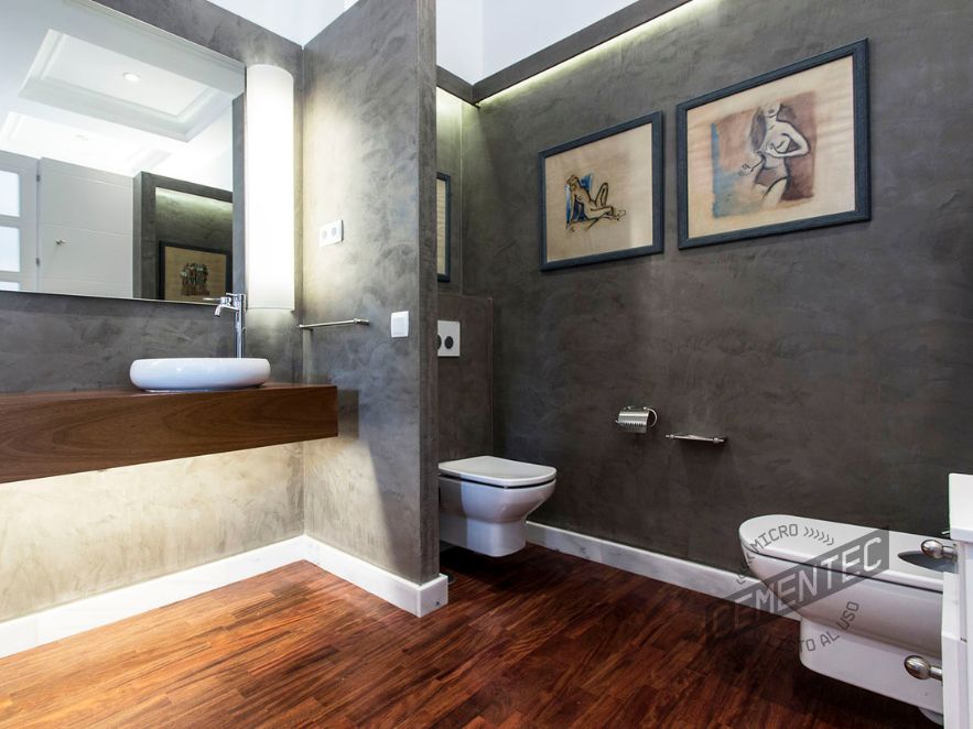 Bathroom with matching wall cladding and parquet flooring.