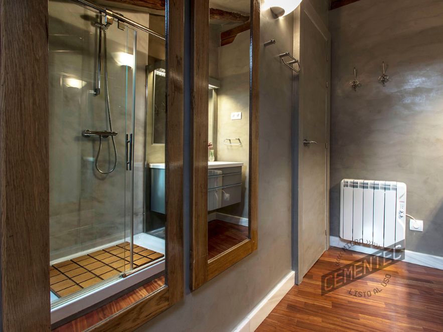 Perspective of one of the microcement and wood bathrooms made by Cementec.