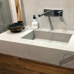 Microcement sink countertop in bathroom made of concrete and covered in Cementec Standard microcement.