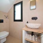 Beige microcement bathroom in attic by Cementec.