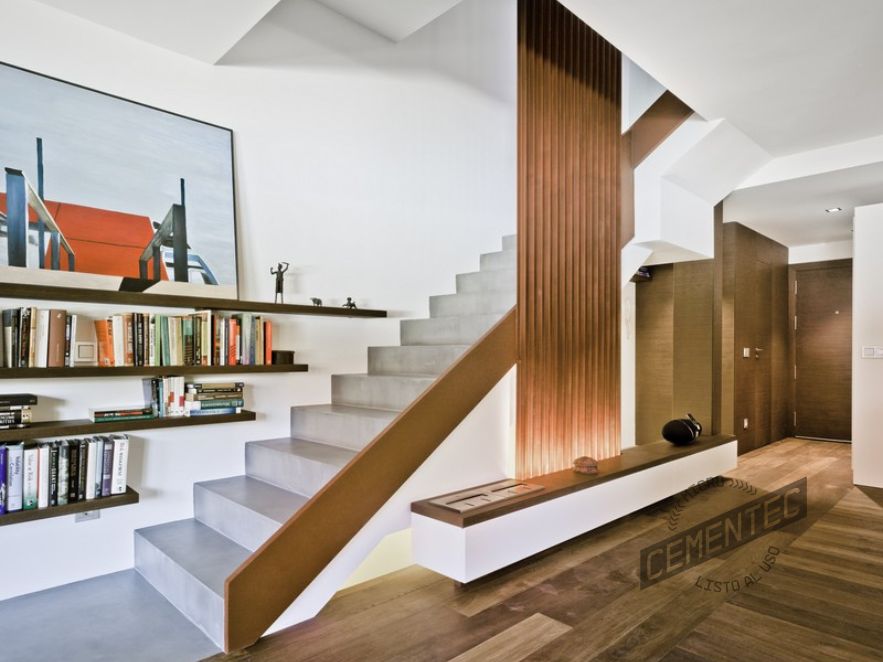 Escalera de microcemento y madera en salón estilo moderno.