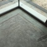 Microcement cracks or fissures in areas adjacent to sliding door enclosures.