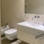 White microcement bathroom in minimal style with marble worktop.