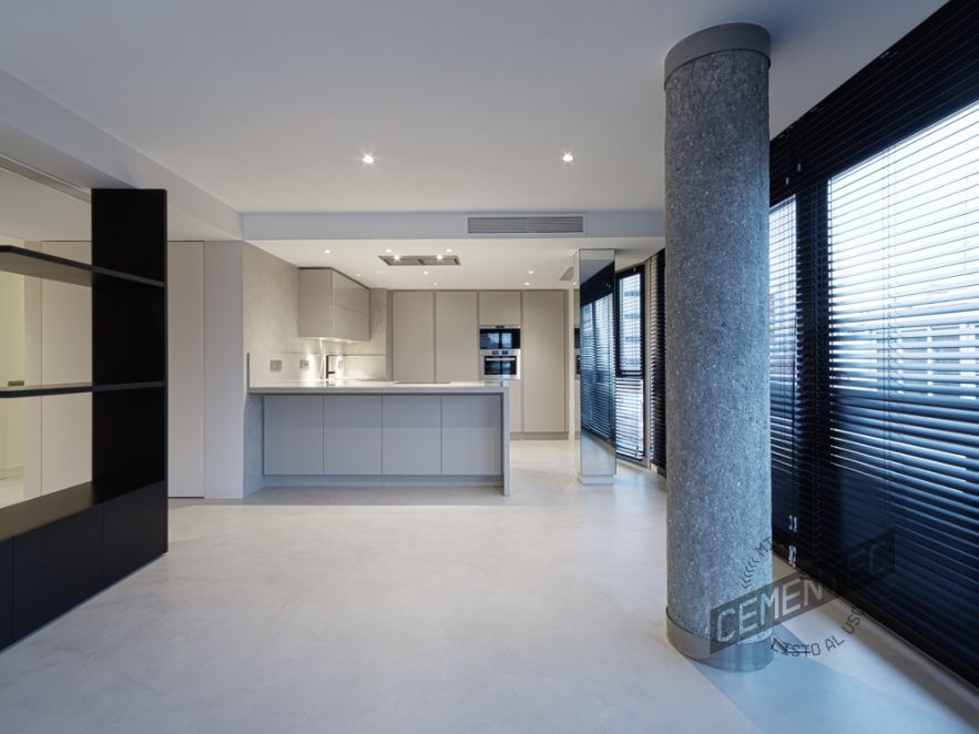 Dining room and kitchen integrated in the same room using Cementec jointless smoothed microcement.